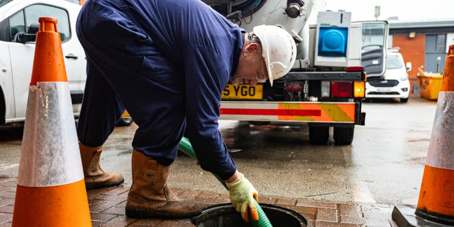 JetVac operator cleaning manhole